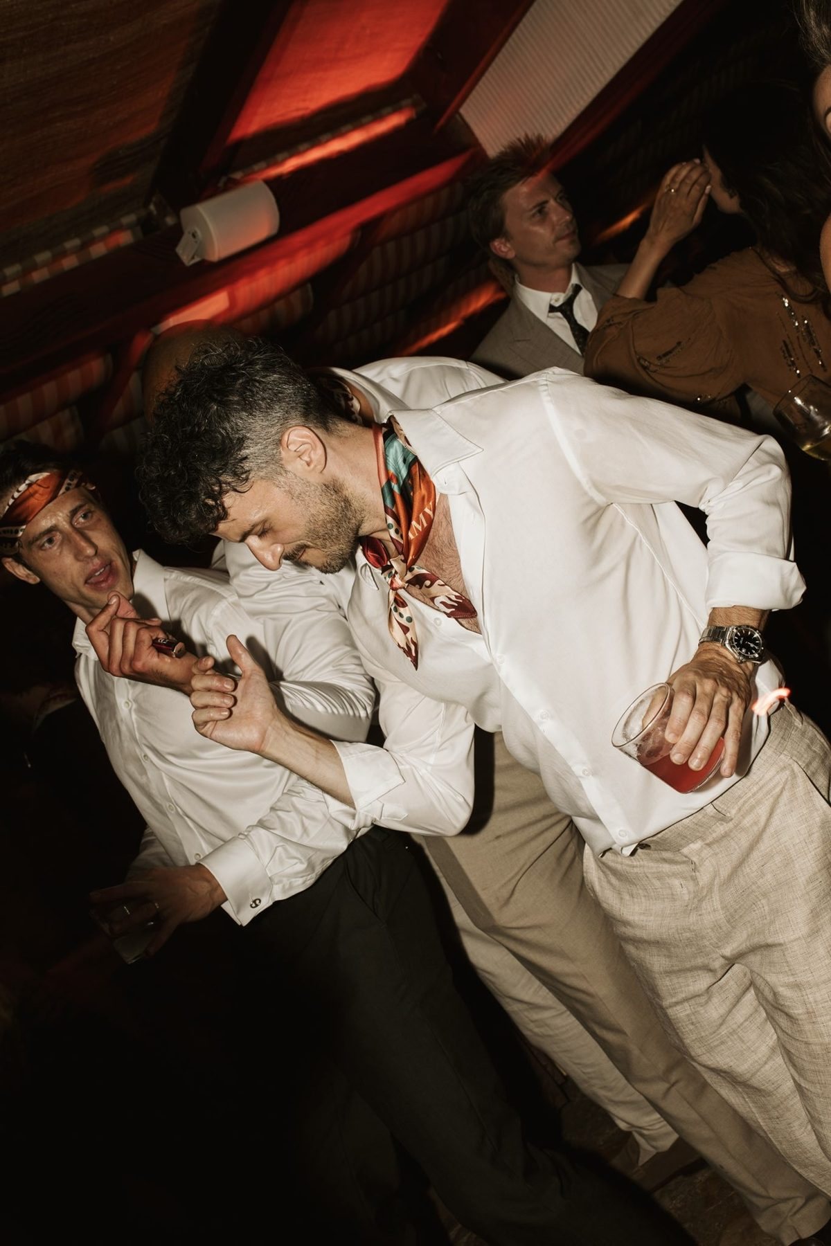 A guest on the dance floor with the scarf tied at his neck