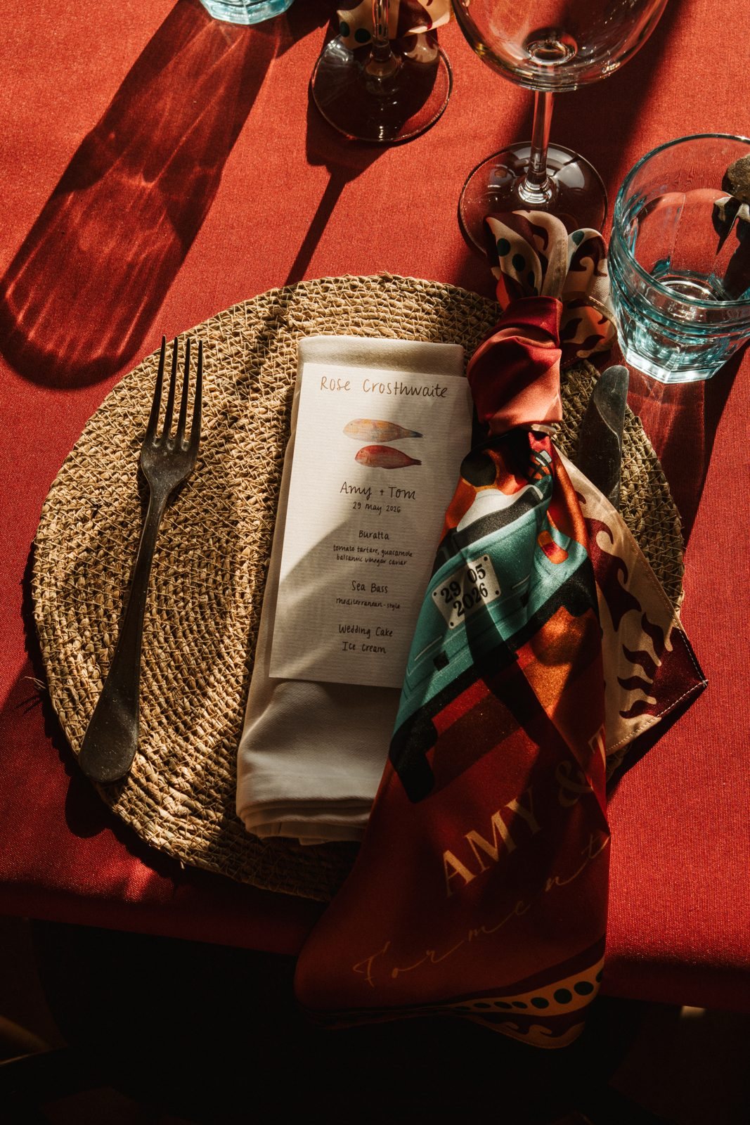 A place setting with the scarf tied beside a handwritten menu