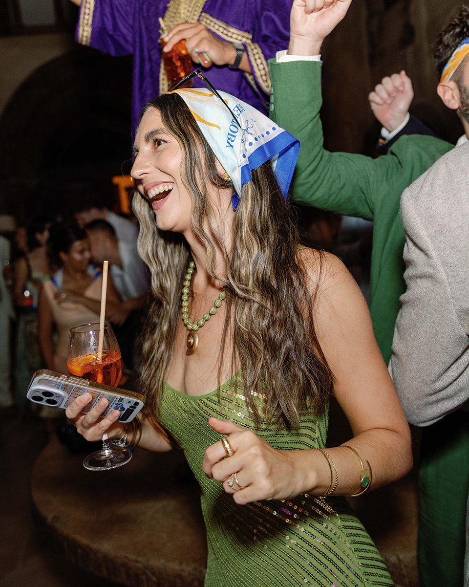 A guest dancing with the scarf tied around her head