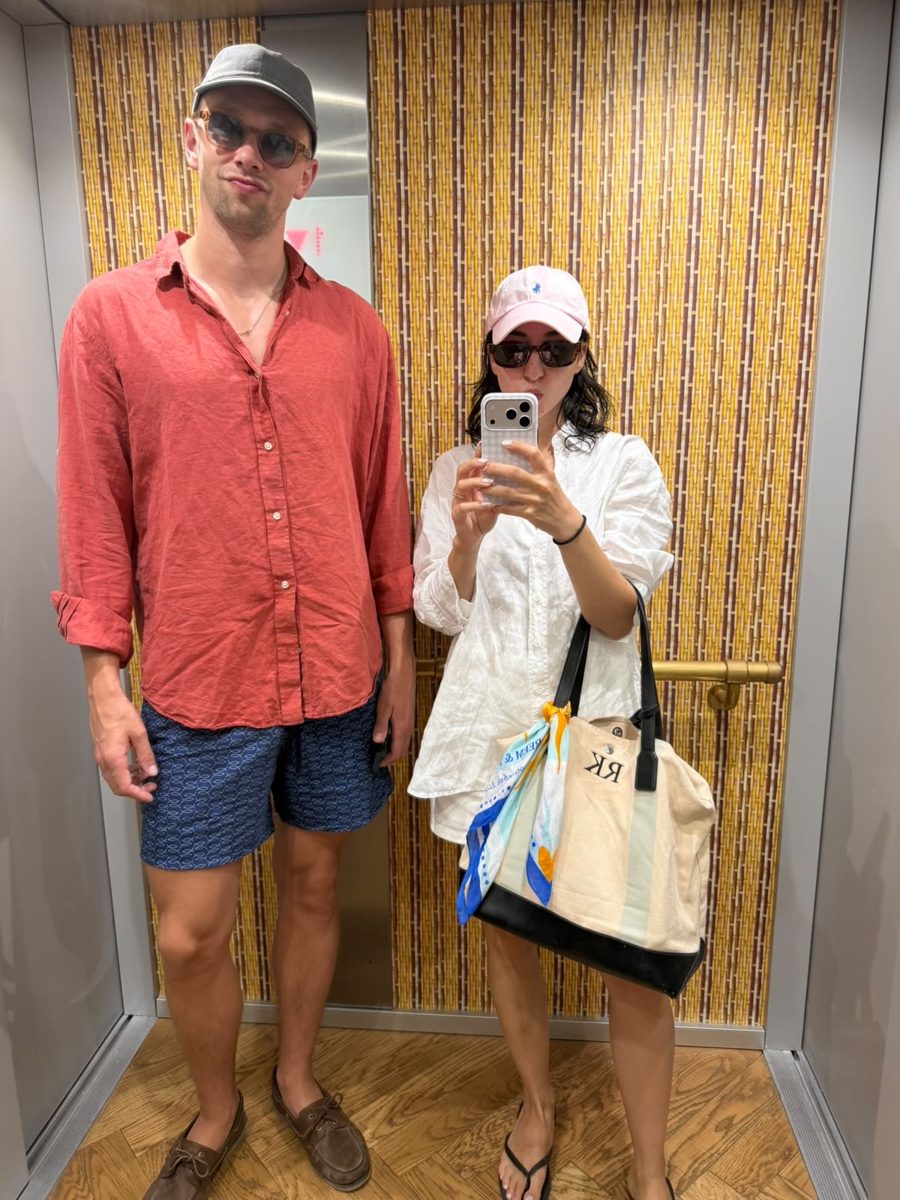 Two guests in a lift, one with the scarf tied to her bag
