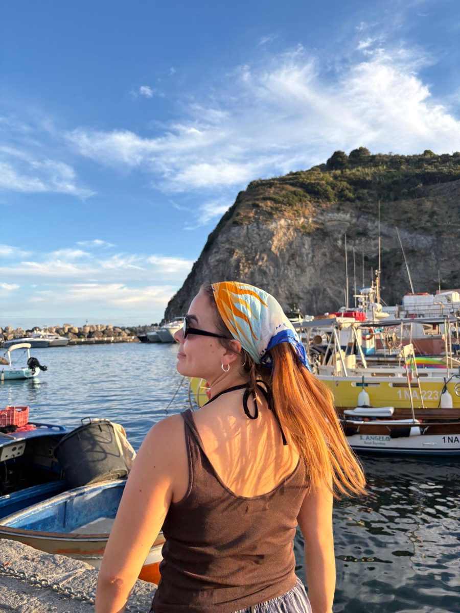 A guest by a harbour wearing the scarf in her hair