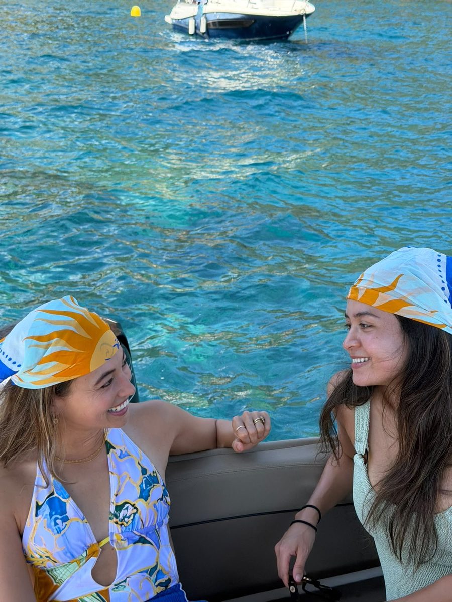 Two friends on a boat wearing the scarves as headscarves