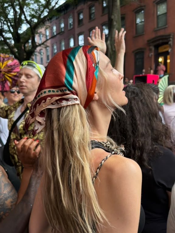A guest at a street party wearing the scarf in her hair