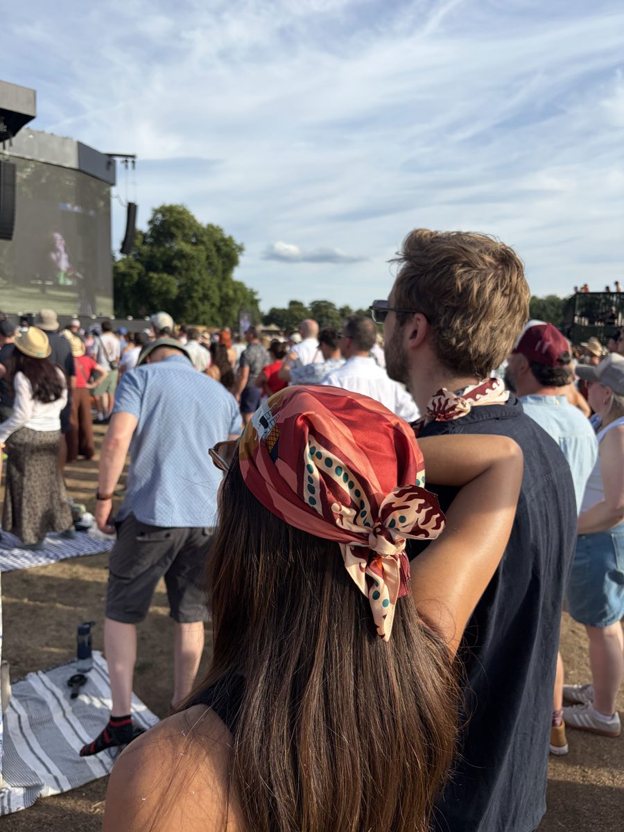 A guest at an outdoor concert with the scarf tied in her hair